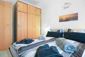 a bedroom with a bed with towels on it at Haus Elbe 5 in Cuxhaven