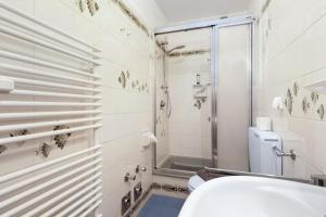 a bathroom with a toilet and a shower at Haus Elbe 5 in Cuxhaven +8 photos