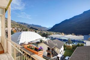 a balcony with a view of a town and mountains at Vanna House in Saint Vincent