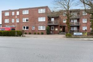an empty street in front of a brick building at Haus Elbe 5 in Cuxhaven