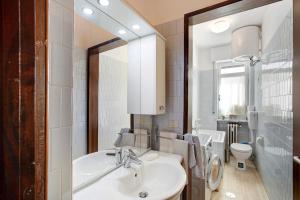 a bathroom with a sink and a toilet and a mirror at Vanna House in Saint Vincent +16 photos