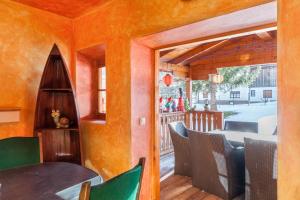 a dining room with orange walls and a table and chairs at Ferienhaus Wechner in Häselgehr