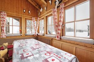a bedroom with a bed in a room with windows at Untersinnerhof Gsies in Valle Di Casies