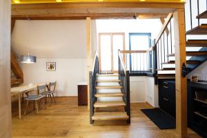 a staircase in a room with a table and a dining room at Wendlingen Ferienwohnung 3 in Freiburg im Breisgau +7 photos