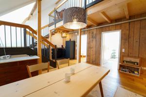 a dining room with a wooden table and a staircase at Wendlingen Ferienwohnung 3 in Freiburg im Breisgau