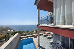 a balcony of a house with a swimming pool at Villa View Grand in Santa Úrsula