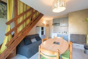 a kitchen and a dining room with a table and a staircase at Chalet 4 Personnes classé 3 étoiles in Luz-Saint-Sauveur +10 photos