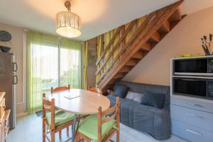 a living room with a table and a couch at Chalet 4 Personnes classé 3 étoiles in Luz-Saint-Sauveur