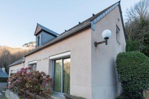 a house with a light on the side of it at Chalet 4 Personnes classé 3 étoiles in Luz-Saint-Sauveur