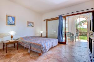 a bedroom with a bed and a sliding glass door at Appartamenti Castle in Campo nell'Elba +45 photos
