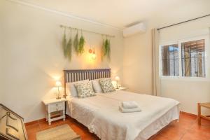 a bedroom with a bed and a window at Villa Jardin Tropical in Manilva +26 photos