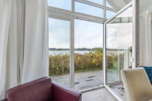 a living room with a large sliding glass door at Brombeeruferhaus in Kosel