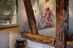 a wooden shelf in a kitchen with a picture on the wall at Gästehaus Siebter Himmel in Burkheim +122 photos