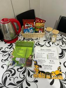 a table with some food and snacks on it at Vila do Chaves Prof Girafales 15 in Itajaí