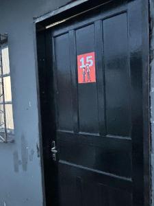 a black door with a sign on it at Vila do Chaves Prof Girafales 15 in Itajaí