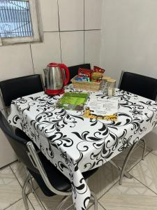 a table with a black and white table cloth at Vila do Chaves Prof Girafales 15 in Itajaí +4 photos
