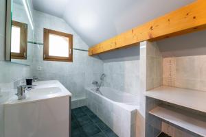 a bathroom with a sink and a bath tub at Le Revers in Aillon-le-Jeune +19 photos