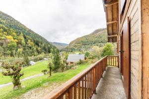 a balcony of a house with a view of the mountains at Le Revers in Aillon-le-Jeune