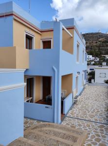 a building with a blue sign in front of it at Anemi Leros Apartments 3 in Panteli +9 photos