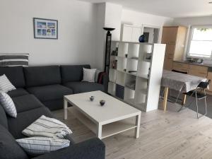 a living room with a couch and a table at Ferienwohnung Bäumchenblick in Müllheim