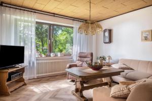 a living room with a couch and a tv at Ferienwohnung Loy in Rastede