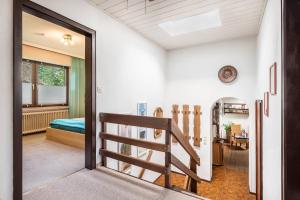 a door leading to a room with a bed and a staircase at Ferienwohnung Loy in Rastede