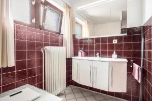 a bathroom with a sink and a mirror at Ferienwohnung Loy in Rastede +20 photos