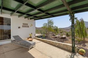 a patio with a bench and a view of the desert at La Finca Las Estrellas in Tarajalejo