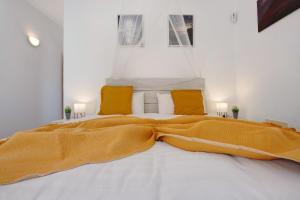 a bedroom with a large bed with a yellow blanket at La Finca Las Estrellas in Tarajalejo