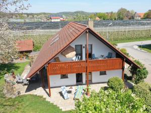 a house with a large roof with a balcony at Ferienwohnung Zerlaut in Langenargen