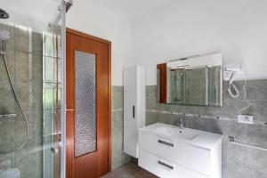 a bathroom with a sink and a shower and a mirror at Casa Tua - Avise in Avise +19 photos