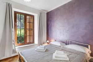 a bedroom with a bed with two towels on it at Casa Tua - Avise in Avise