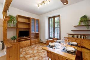 a large living room with a table and a television at Casa Tua - Avise in Avise