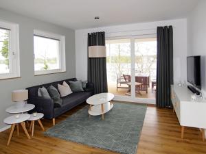 a living room with a couch and a table at Marina Zernsdorf in Zernsdorf