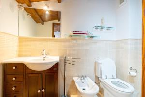 a bathroom with a sink and a toilet and a sink at Casina La Torretta - By The Walls in Lucca +6 photos