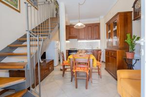 a kitchen and dining room with a table and chairs at Casina La Torretta - By The Walls in Lucca