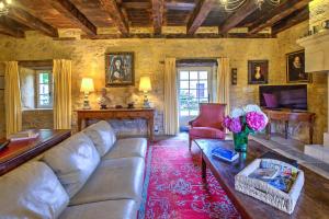 a living room with a couch and a table at La Bourgeoisie in Domme