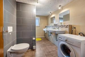 a bathroom with a toilet and a sink and a washing machine at Bad day good day in Horn-Bad Meinberg +42 photos