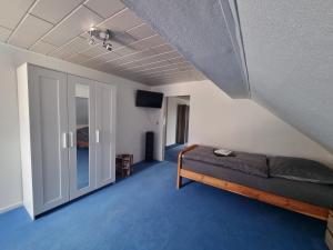 a bedroom with a bed and a sliding glass door at Ferienwohnung Familie Kleinbauer in Wirsberg
