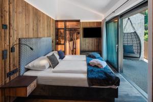 a bedroom with a large bed and a balcony at Chalet Ski in Selva di Val Gardena
