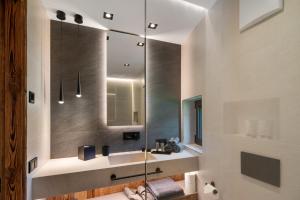 a bathroom with a sink and a mirror at Chalet Ski in Selva di Val Gardena +31 photos