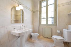 a white bathroom with a sink and a toilet at Viasambuco in Iseo +27 photos