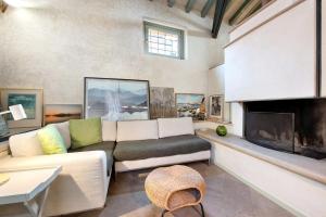 a living room with a couch and a fireplace at Viasambuco in Iseo
