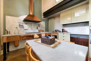 a kitchen with a counter with a basket on a table at Viasambuco in Iseo