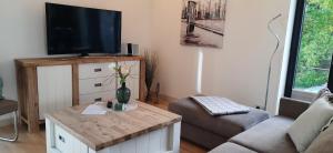 a living room with a tv and a couch at Gardensuite Binz in Binz