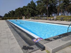 a swimming pool with two people in the water at Gardensuite Binz in Binz