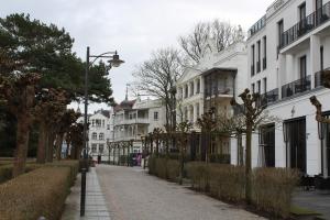 a city street with white buildings and a street light at Gardensuite Binz in Binz