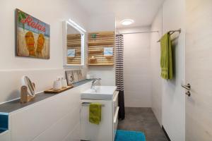 a bathroom with a sink and a shower at Ferienwohnung mit eigenem Eingang in Deggenhausertal +12 photos