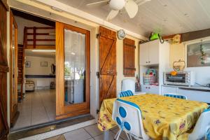 a room with a table and chairs and a kitchen at Les Eaux Vives 1 in Fleury