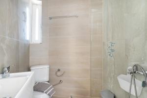 a bathroom with a toilet and a sink and a shower at Iguana studio 4 in Preveza +18 photos